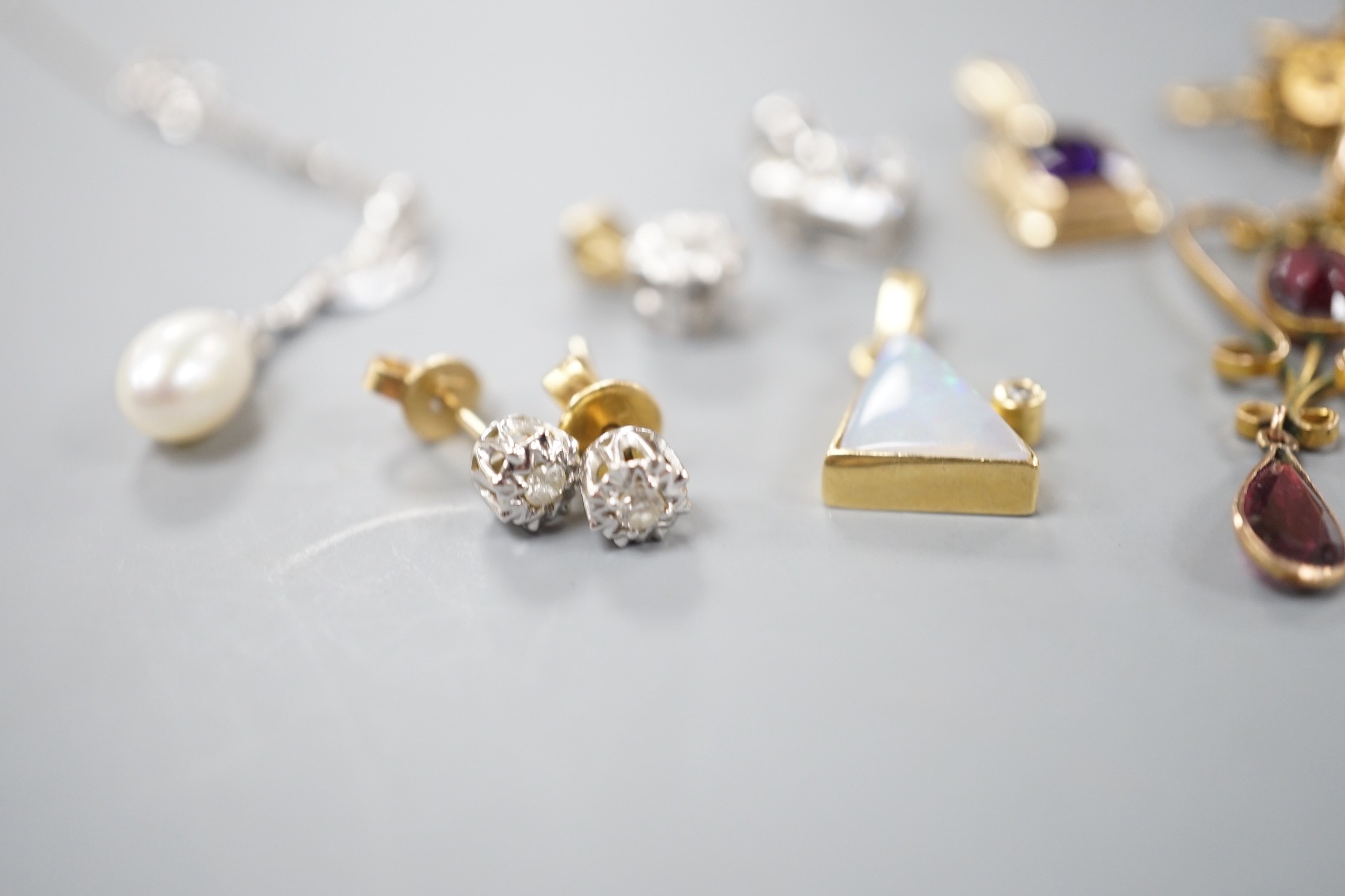 Mixed jewellery including a pair of Victorian 15ct and diamond chip earrings, a modern amethyst pendant, a garnet set yellow metal pendant, two pairs of 750 and diamond set ear studs, a pair of 750 white metal, tanzanite